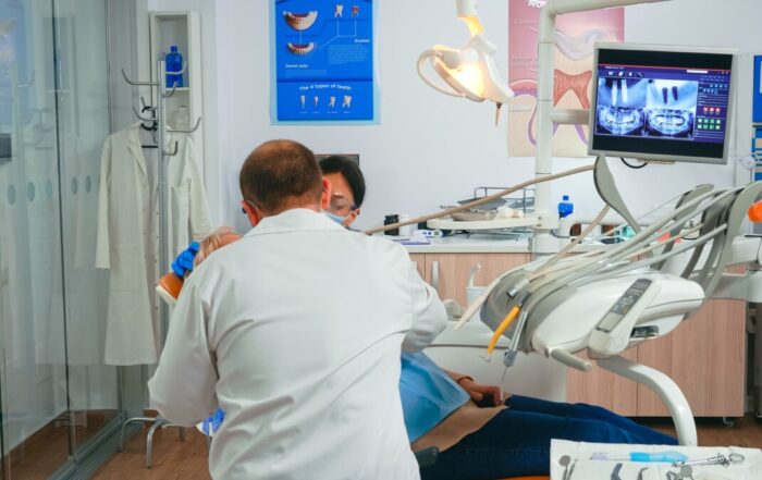Oral surgeon performing surgery installing implant