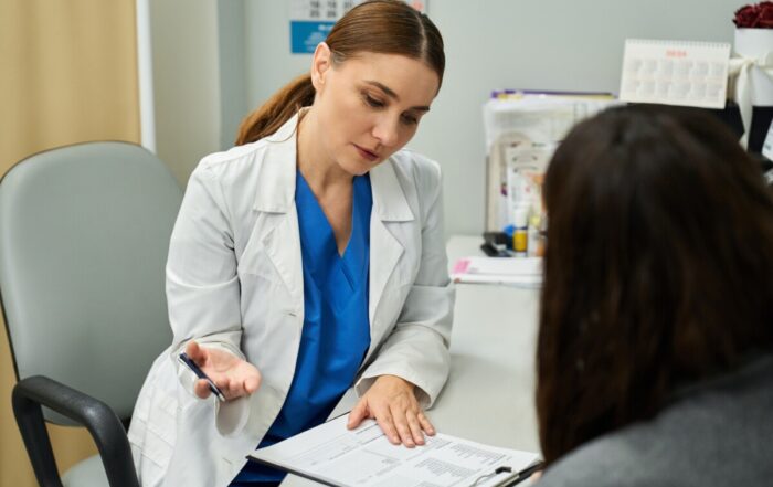 Gynecologist provides health guidance to female patient in modern clinic setting